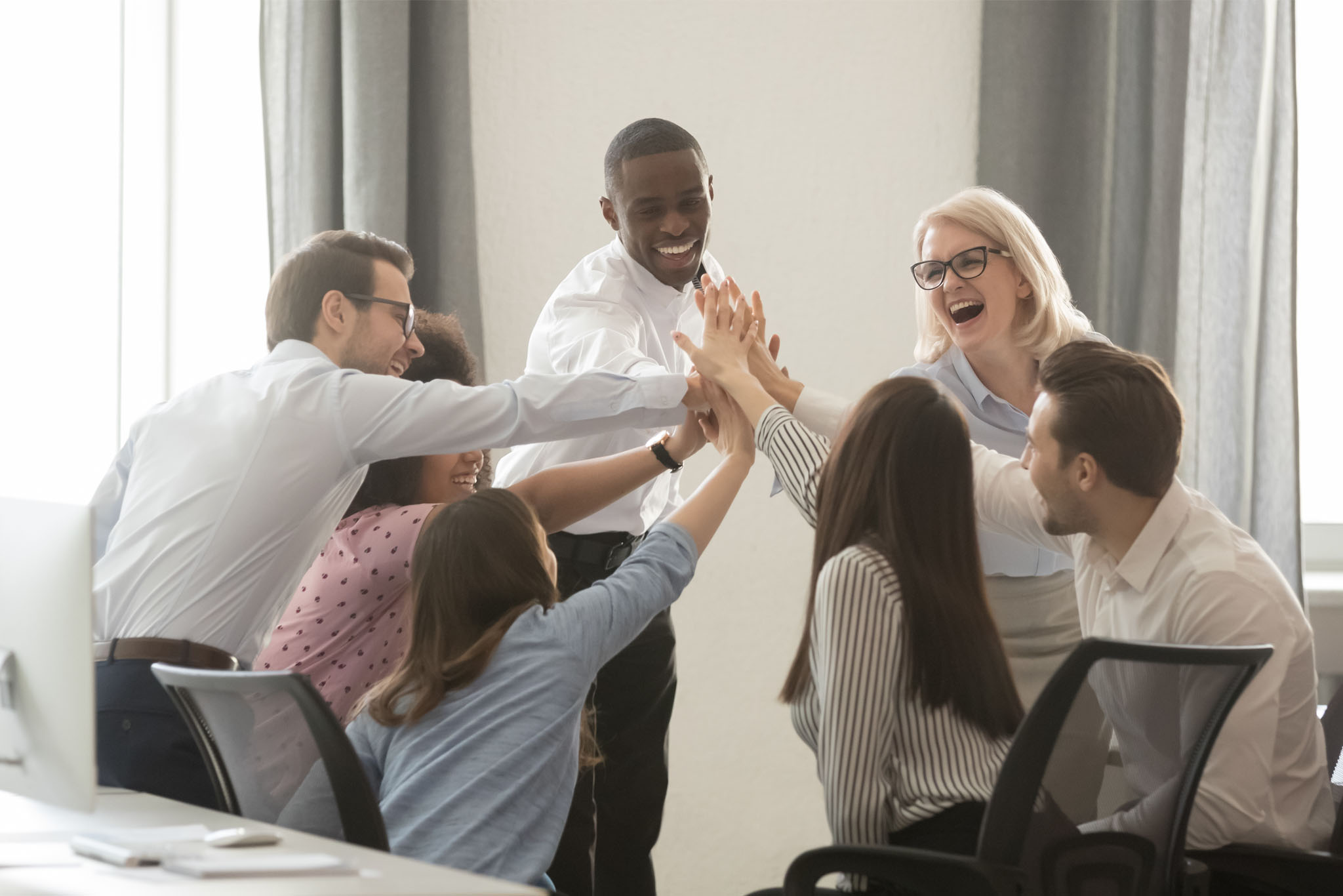 Happy diverse employees business team engaged in teambuilding giving high-five Happy multicultural employees business team engaged in teambuilding giving high five hands celebrate corporate success motivated by shared win great result together in office, trust integrity concept