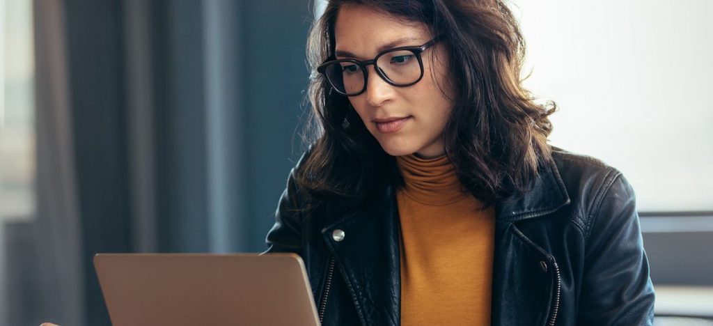 A woman searches the internet for board positions.