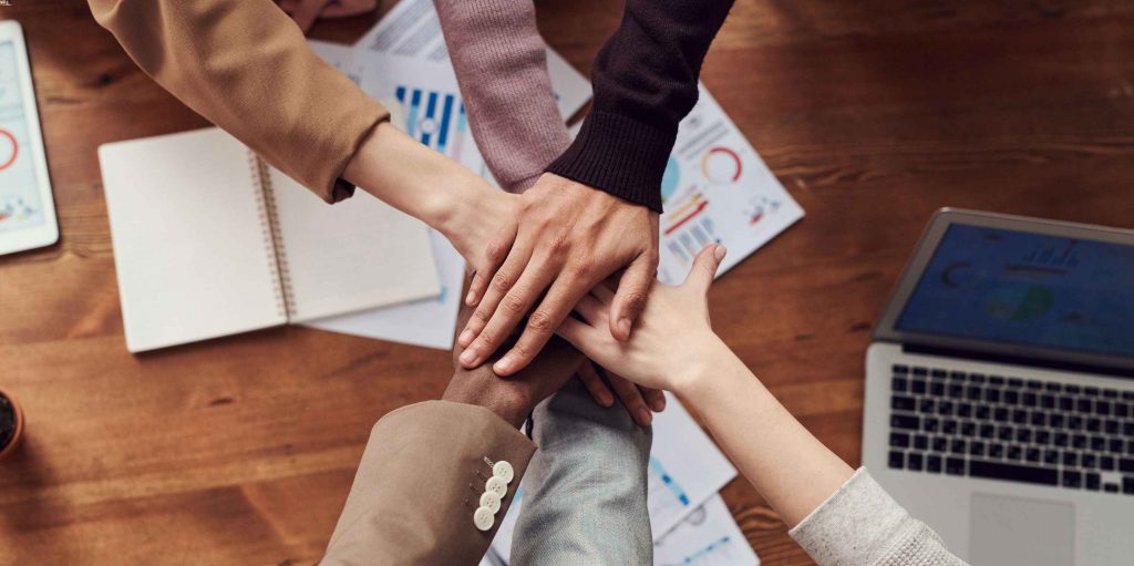 hands stacked in team huddle