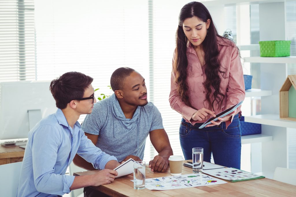 A group of young professionals work together at a meeting.