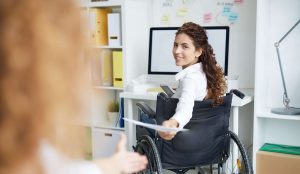 woman holding paper in office